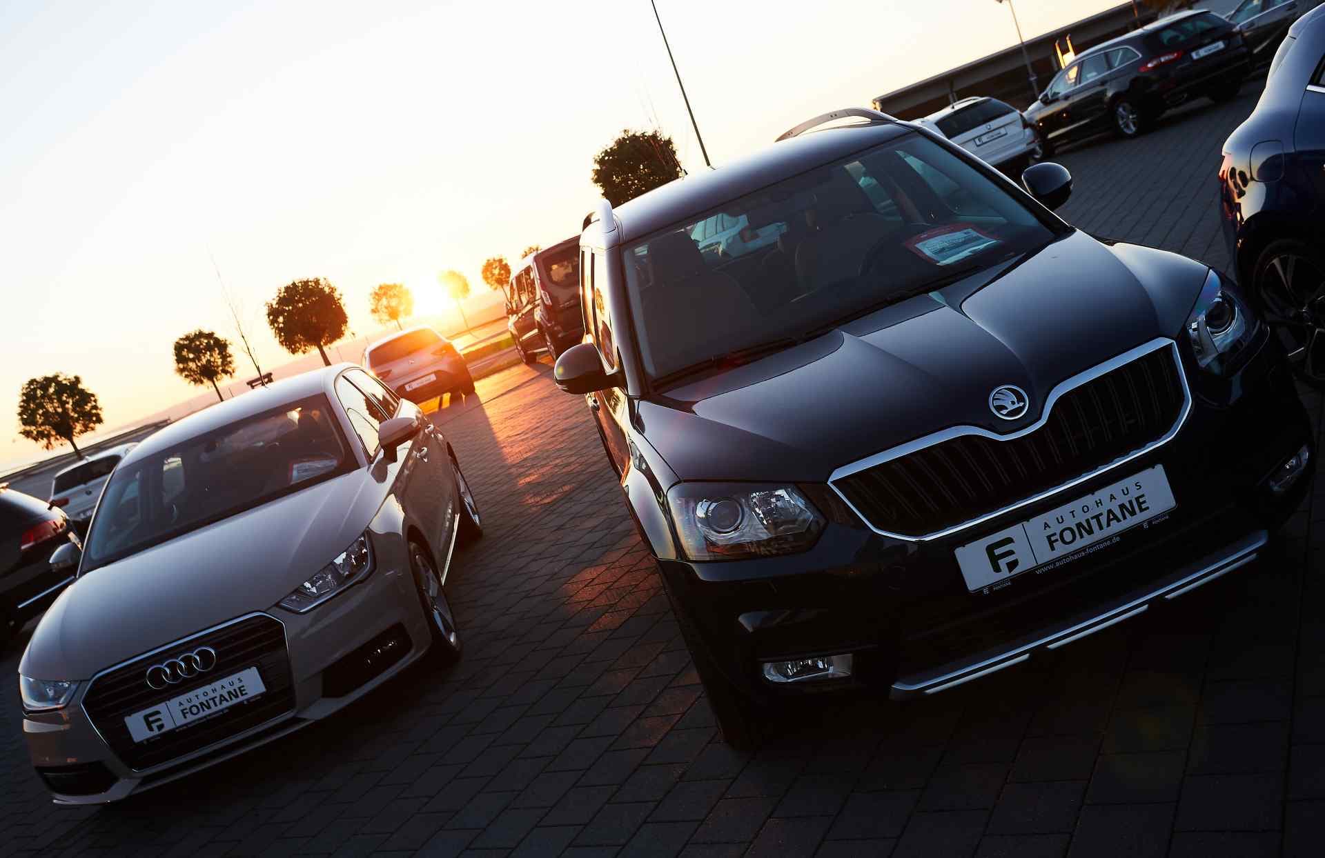 Vehicles on the forecourt against a low winter sun